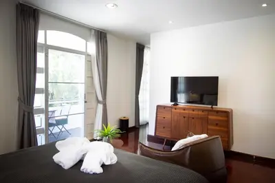 a hotel room with a bed with two towels at Spacious 4-Bedroom Oasis in the Heart of Sukhumvit in Bangkok
