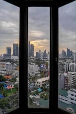 a view of a city skyline from a window at PEONY Rustic Apartment Sukhumvit, Nana BTS in Bangkok