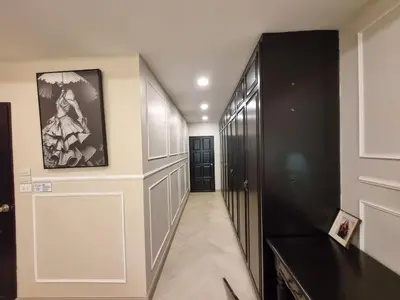a hallway with a black and white painting on the wall at RB9 Oliver's House in Kaset in Ban Yang