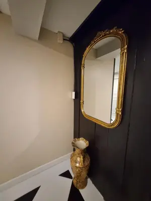 a mirror and a vase on a floor in a room at RB9 Oliver's House in Kaset in Ban Yang