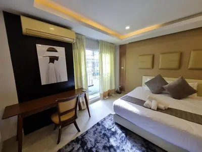 a hotel room with a bed and a desk and a desk at RB9 Oliver's House in Kaset in Ban Yang