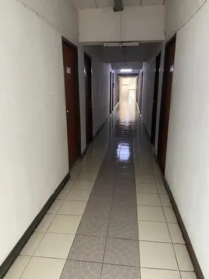 an empty hallway of an office building with a long corridor at PTT Mansion ปทิตา แมนชั่น in Ban Zong Katiam