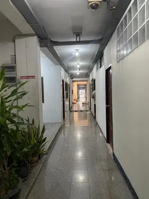 a hallway of an office building with plants in it at PTT Mansion ปทิตา แมนชั่น in Ban Zong Katiam