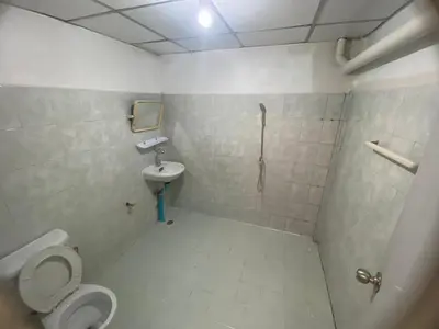 a bathroom with a toilet and a sink at PTT Mansion ปทิตา แมนชั่น in Ban Zong Katiam