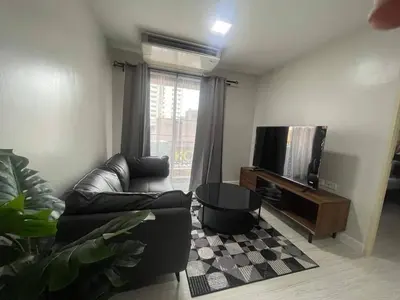 a living room with a couch and a tv at MeStyle Sukhumvit Banana มีสไตล์สุขุมวิท บางนา in Bangna