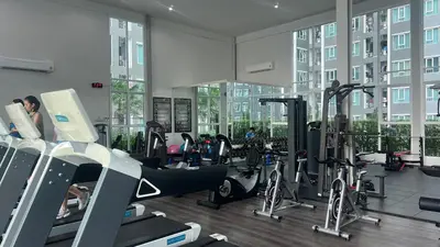 a gym with treadmills and exercise bikes in a building at GM bangson home in Bangkok