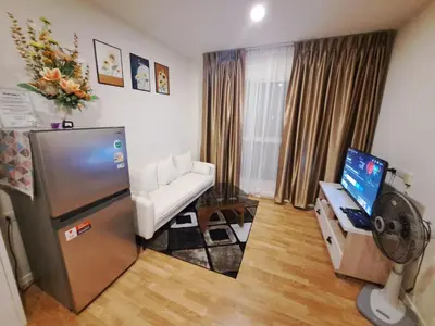 a living room with a refrigerator and a couch at A family room at Lumpini Ville Sukhumvit 101-1 by Pikul in Bangkok