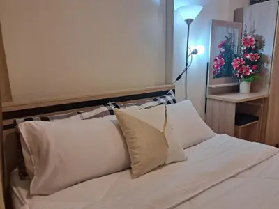 a bed with white sheets and pillows in a room at A family room at Lumpini Ville Sukhumvit 101-1 by Pikul in Bangkok