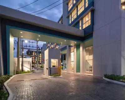 a large building with a driveway in front of it at A family room at Lumpini Ville Sukhumvit 101-1 by Pikul in Bangkok