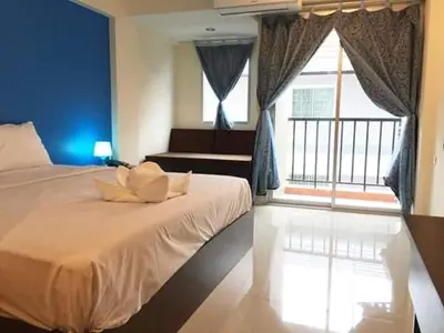 a bedroom with a large bed and a large window at Sixty Star Love Place Hotel in Bangkok