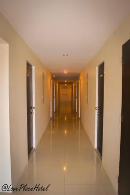 a hallway of a hotel with a long corridor at Sixty Star Love Place Hotel in Bangkok