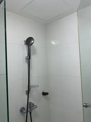 a bathroom with a shower with a glass door at Appartement douillet pool fitness in Bangkok