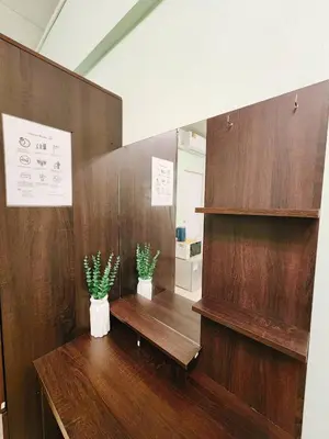 a room with two potted plants on a wooden wall at 703-STP Homely room Free Wi-Fi and Near BTS line in Bangkok