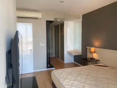 a bedroom with a bed and a tv in a room at Mövenpick Residence Ekkamai in Sathani Khlong Tan