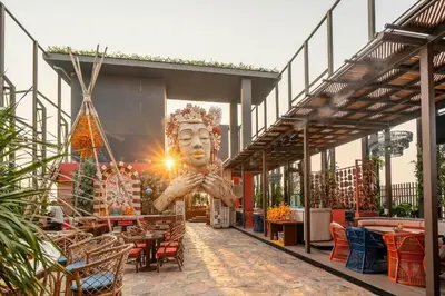 a building with a statue of a head in the middle at Mövenpick Residence Ekkamai in Sathani Khlong Tan