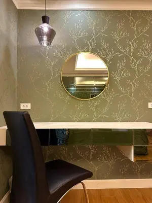 a mirror on a wall next to a desk with a chair at BangrakHomey - Cozy private Apartment in State tower bangkok in Bangkok