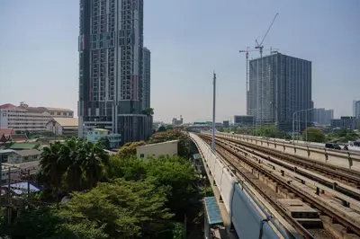 a long train track in a city with tall buildings at iCheck inn Thapra in Bangkok