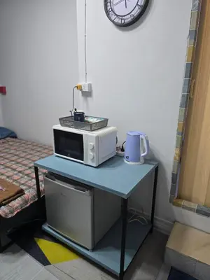 a microwave sitting on top of a table at 104 Peaceful and Cosy apartment near BTS with free WiFi in Bangkok