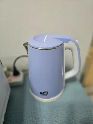 a white coffee cup sitting on a counter at 104 Peaceful and Cosy apartment near BTS with free WiFi in Bangkok