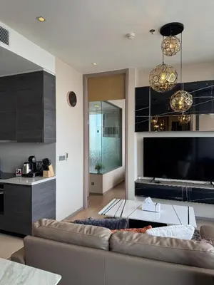 a living room with a couch and a tv at The Esse Asoke in Bangkok
