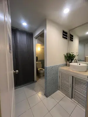 a bathroom with a sink and a toilet at Youjia Youth Hostel in Bang Rak