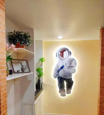a painting of a astronaut hanging on a wall at Youjia Youth Hostel in Bang Rak