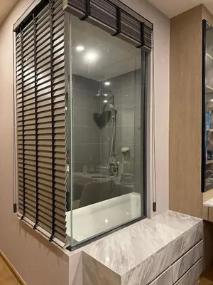 a bathroom with a shower and a glass window at Condo Luxe Siam Pool 360 Near BTS Shopping in Bangkok