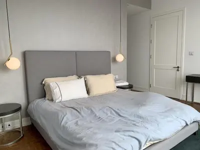 a bedroom with a large bed with two pillows at Ritz Carlton Residences in Bangkok