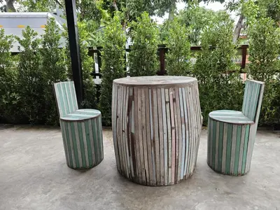 two chairs and a table with two stools at บ้านรังนก The Bird Nest Homestay & Coffeeshop in Samut Prakan