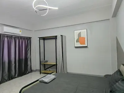 a room with a bed and a ceiling fan at SRINN House, Bangkok in Bangkok