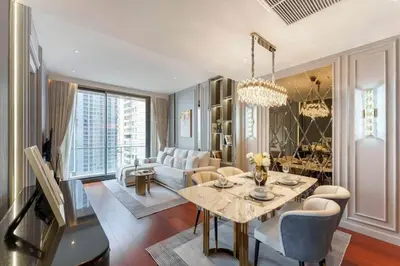 a living room with a table and a couch at Prime Area Super Cozy Luxury 2 bedroom Asoke BTS in Bangkok