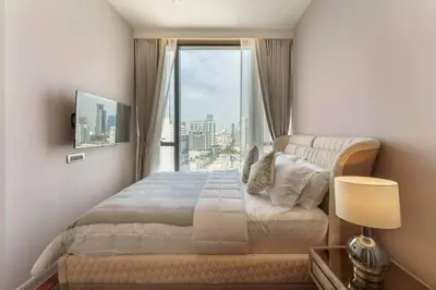 a bedroom with a bed and a large window at Prime Area Super Cozy Luxury 2 bedroom Asoke BTS in Bangkok