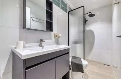 a white bathroom with a sink and a shower at AB House in Bangkok