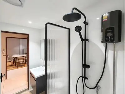 a bathroom with a shower and a mirror at AB House in Bangkok