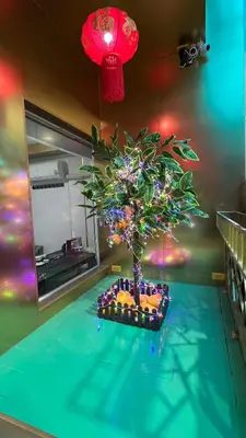 a christmas tree on a table in a room at Golden Mango home hotel \u91d1\u8292\u679c\u4e4b\u5bb6\u9152\u5e97 in Bangkok