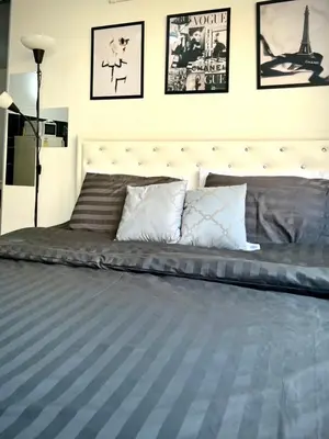 a bedroom with a large bed with posters on the wall at Impact Arena Condo 2Rooms C3 by GoodRoom24 in Ban Bang Phang