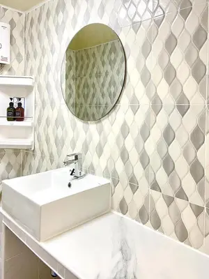 a bathroom with a white sink and a mirror at Impact Arena Condo 10fl by GoodRoom24 in Ban Song Hong
