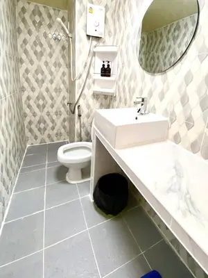 a bathroom with a sink and a toilet at Impact Arena Condo 10fl by GoodRoom24 in Ban Song Hong