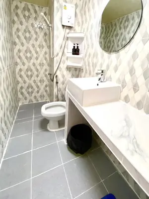 a bathroom with a sink and a toilet at Impact Arena Condo 10fl by GoodRoom24 in Ban Song Hong