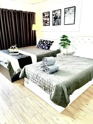 a bedroom with two beds with towels on a table at Impact Arena Condo Twin Beds by Goodroom24 in Ban Song Hong