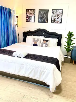 a bedroom with a large bed with towels on it at Impact Arena Condo 6fl by GoodRoom24 in Ban Song Hong