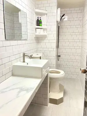 a white bathroom with a sink and a toilet at Impact Arena Condo 6fl by GoodRoom24 in Ban Song Hong
