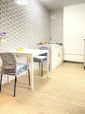a dining room with a table and two chairs at Impact Arena Condo 6fl by GoodRoom24 in Ban Song Hong