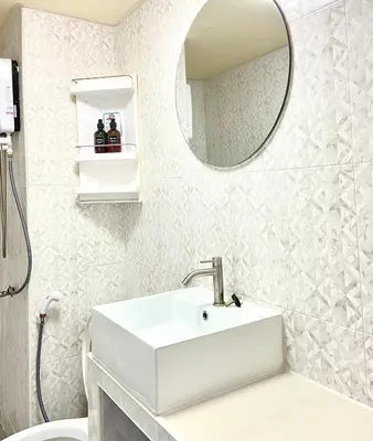 a white bathroom with a sink and a mirror at Impact Arena C8 Condo by GoodRoom24 in Thung Si Kan