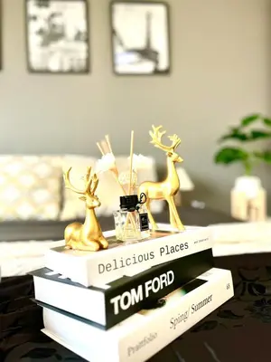 a stack of books with figurines on top of them at Impact Arena Condo C1 by GoodRoom24 in Ban Song Hong