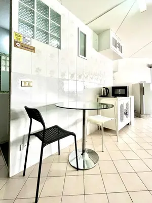 a dining room with a table and a chair at Impact Arena Condo C1 by GoodRoom24 in Ban Song Hong