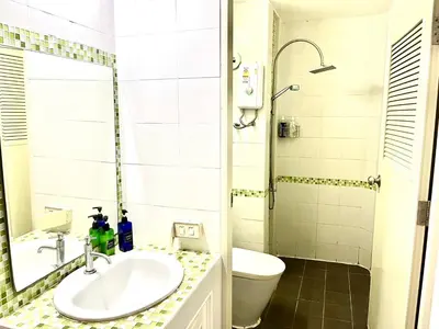 a bathroom with a sink and a toilet and a shower at Impact Arena Condo C1 by GoodRoom24 in Ban Song Hong