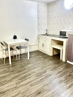 a kitchen with a table and two tables and a sink at Impact Arena Condo C3 Grey by GoodRoom24 in Ban Bang Phang