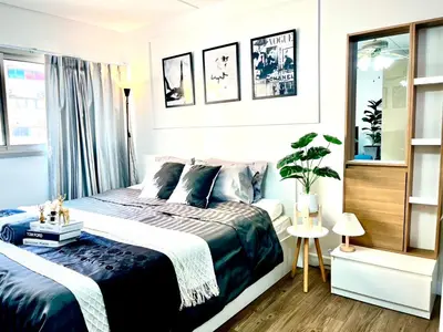 a bedroom with a bed with a blue comforter at Impact Arena Condo C3 by GoodRoom24 in Ban Bang Phang