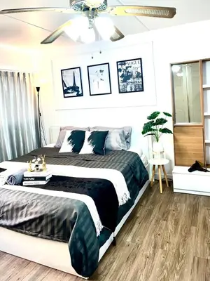 a bedroom with a bed and a ceiling fan at Impact Arena Condo C3 by GoodRoom24 in Ban Bang Phang